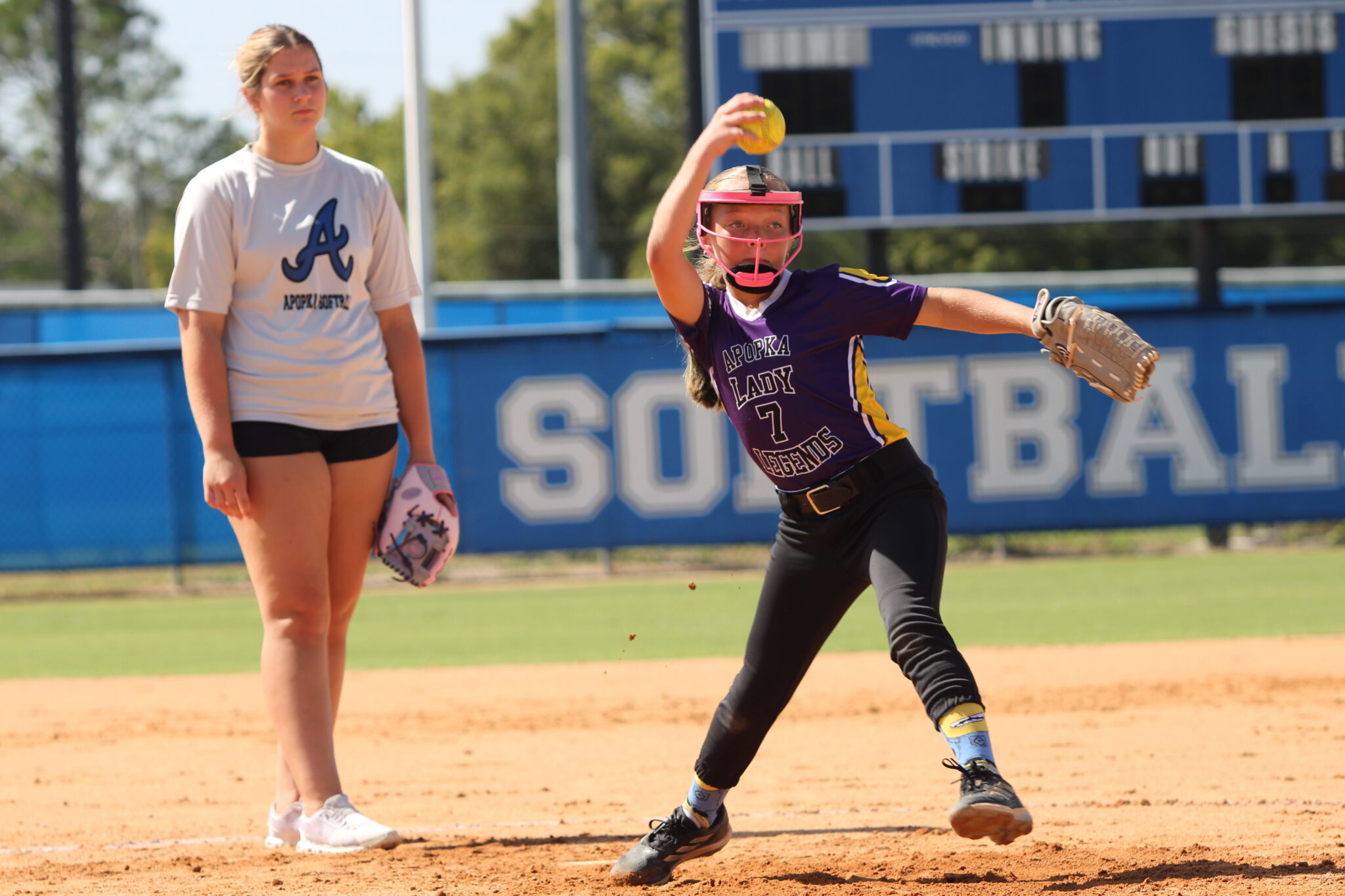 Young camper works through her pitching motion with Blue Darter alum and Eastern Florida freshman, Ava Millspaugh.
