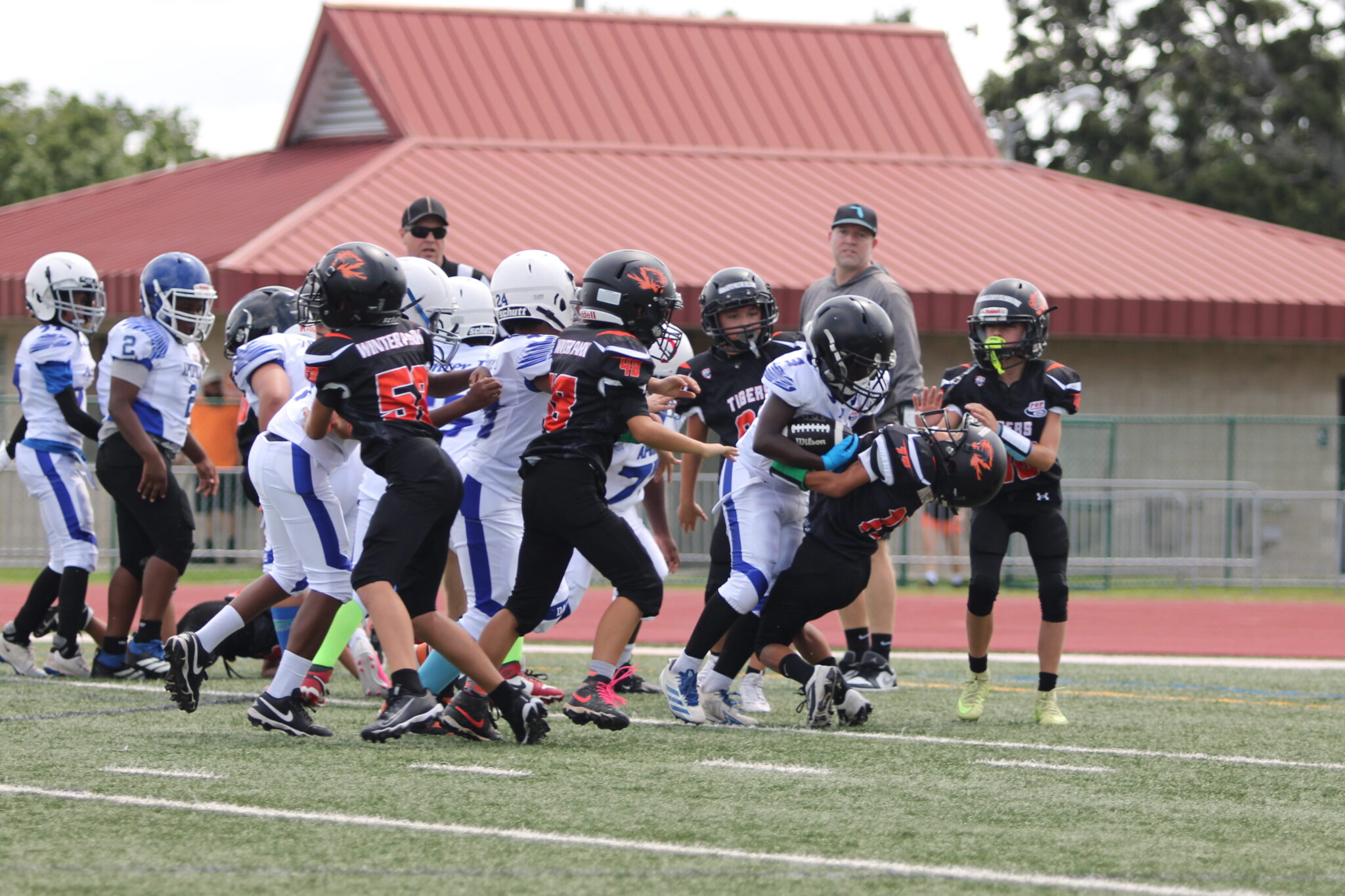 10u RB runs through a Winter Park defender into the endzone.