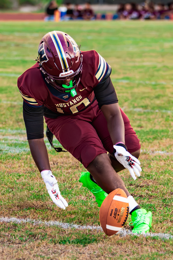 De’Andre Payne recovers a fumble Friday night against Cypress Creek.