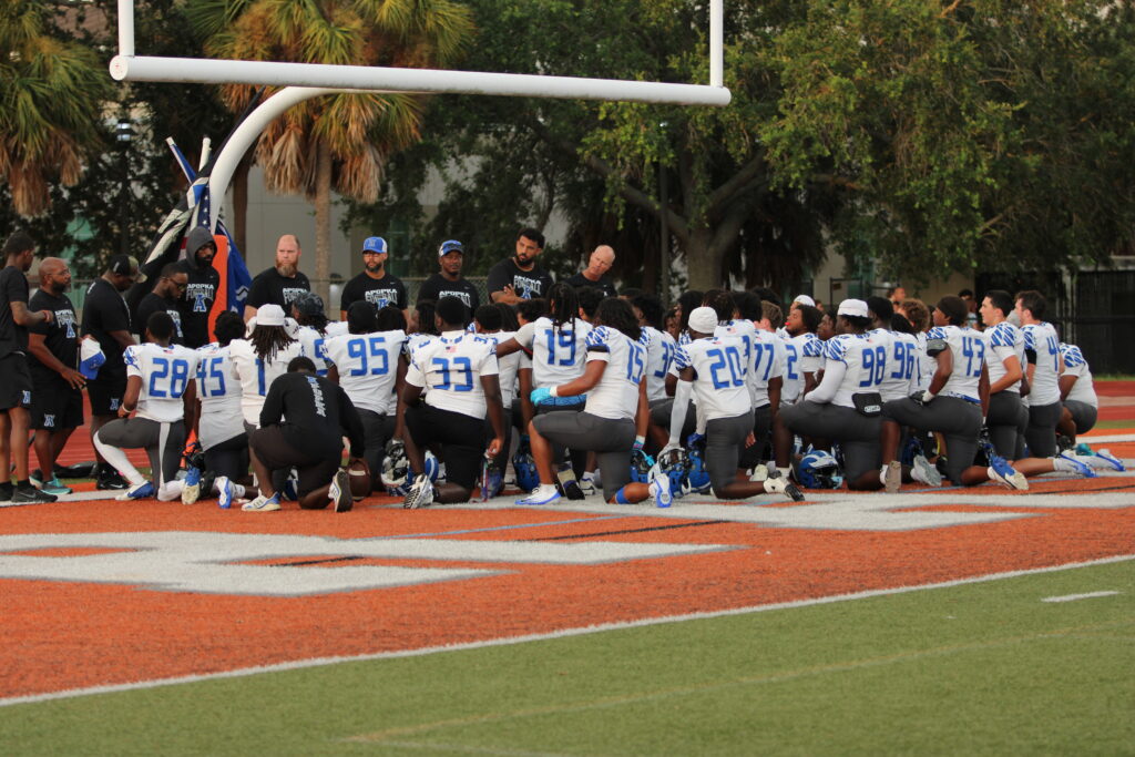 Apopka Blue Darters football team huddles before game against Boone.