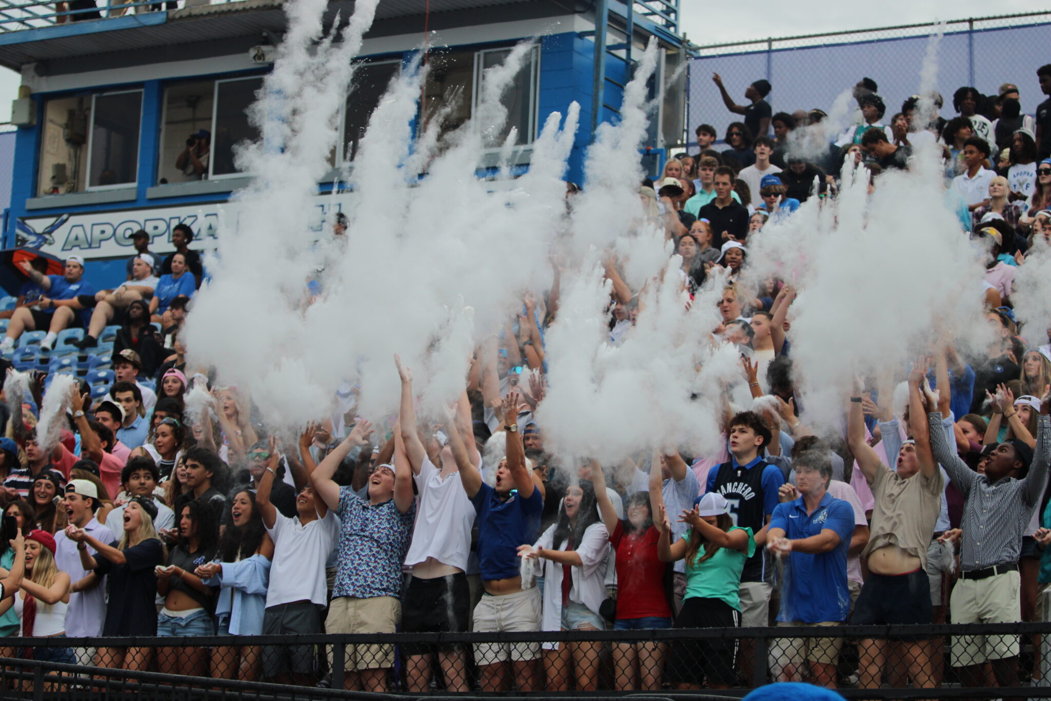 Apopka student section tosses up powder on as the Blue Darters kickoff the game against Winter Park.