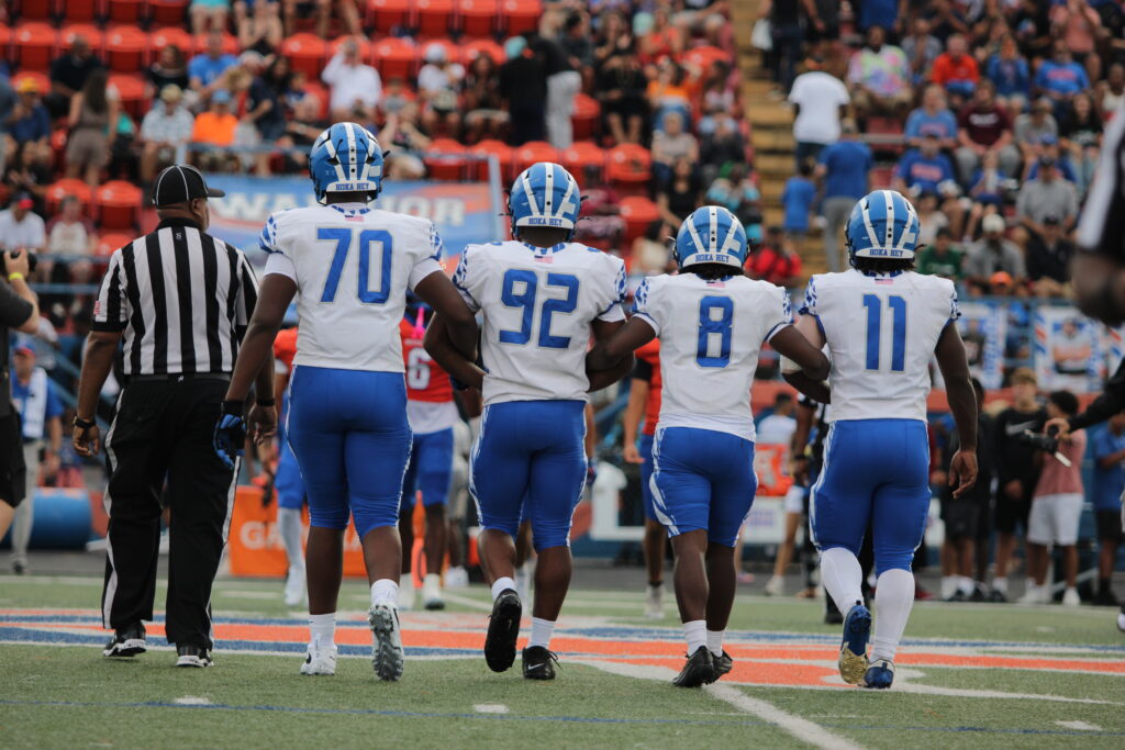 Blue Darter captains walk out for the coin toss at West Orange.