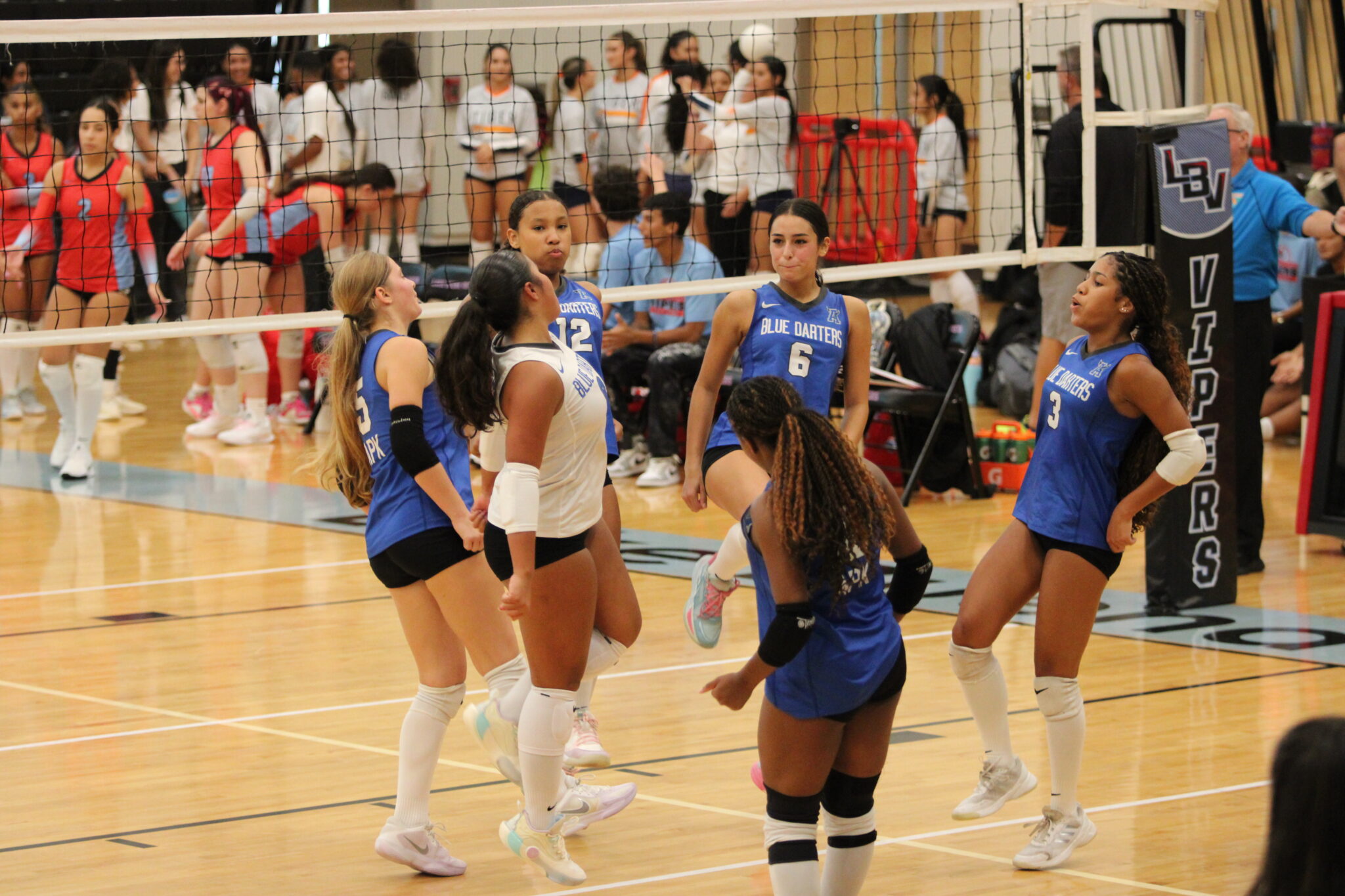 Blue Darters celebrate a late ace against Lake Buena Vista.