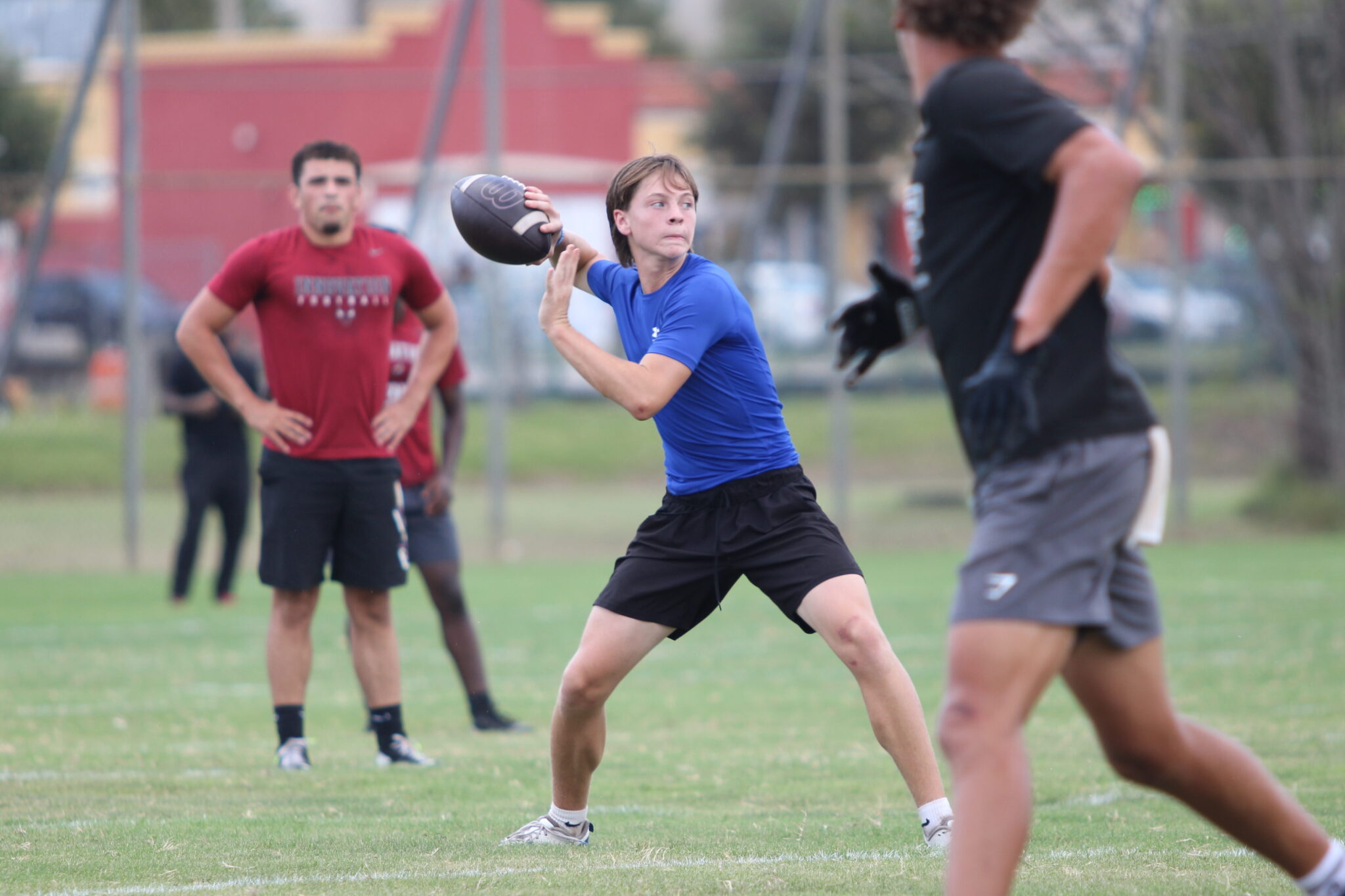 Brodie Bolly winds back a pass in 7-on-7 at Jones High School.