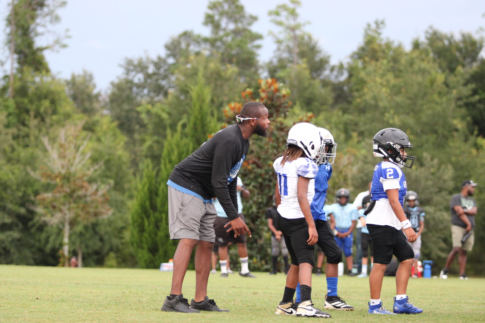 Coach Ced Bryant instructs 10u players.
