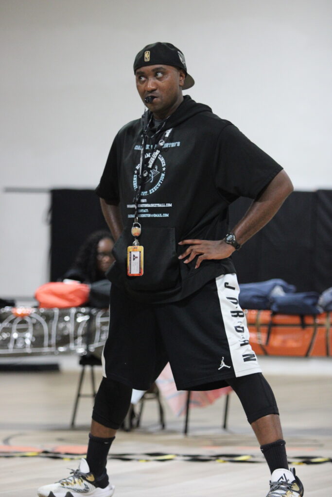Coach Mark Washington watching his campers and coaches drill.