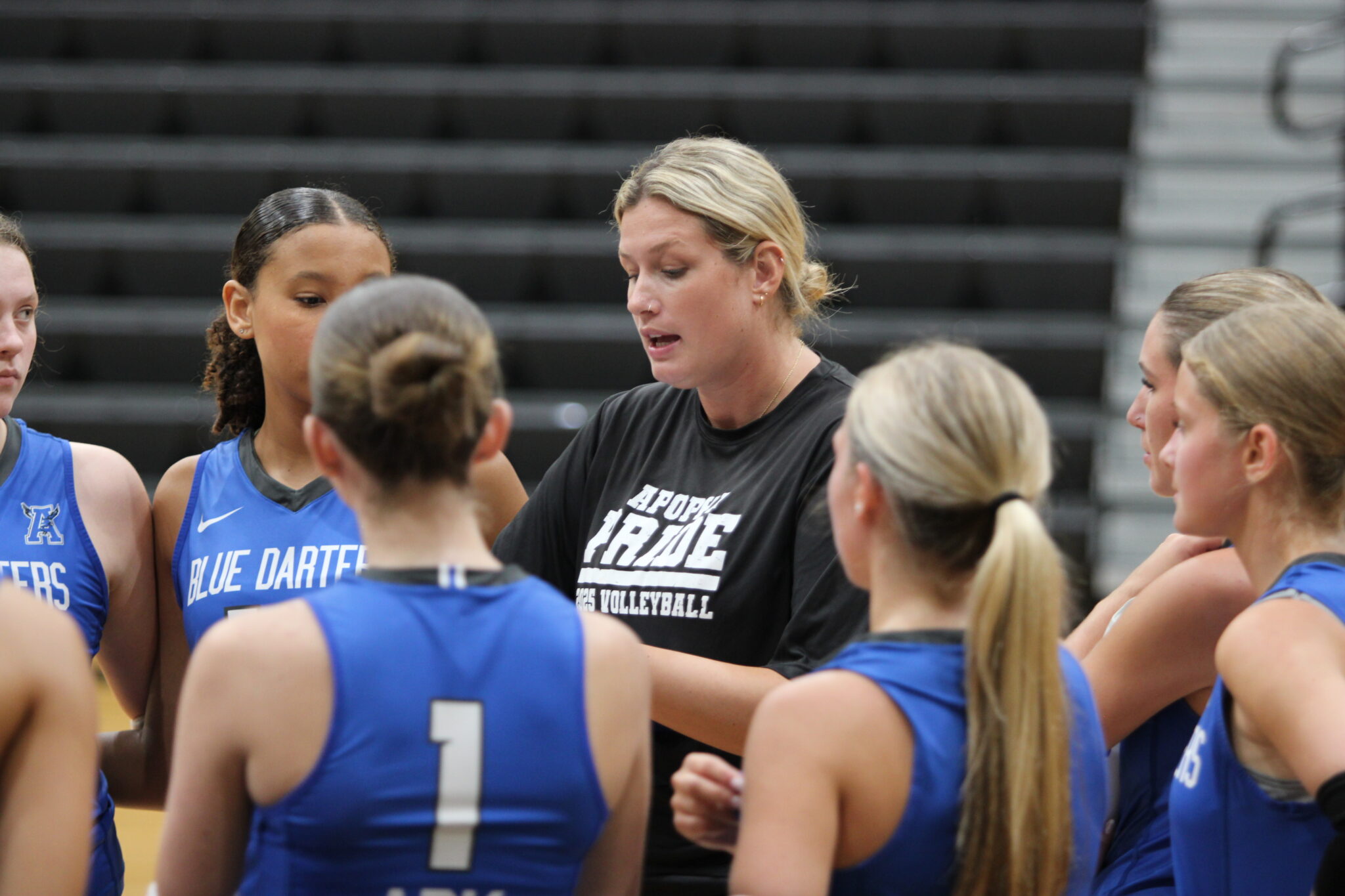Coach Sarah Egbers goes over gameplan for the third set.