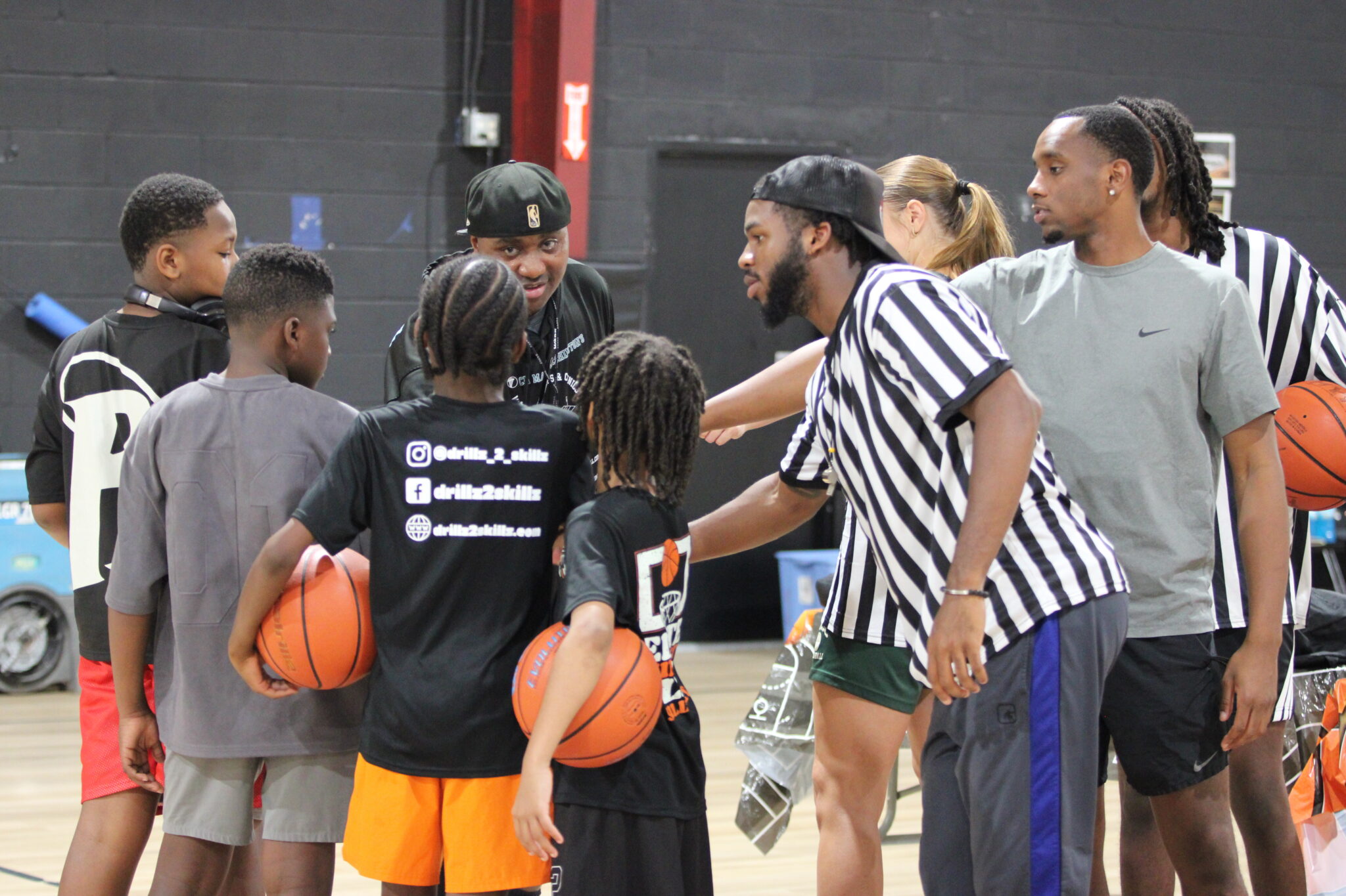 Coaches and campers huddle up at the Back2School hoops camp.