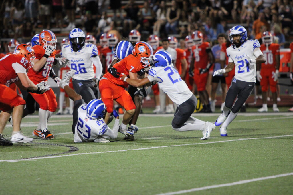 David Wemberly (23) and Kamron Medina (29) tackle a Boone ballcarrier in the second quarter of their week 1 matchup.