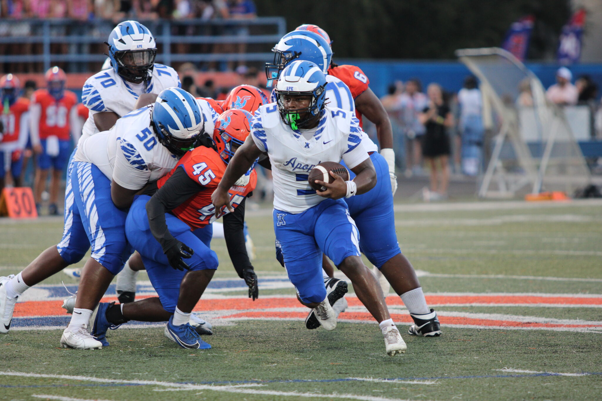 Jalen Parmely takes a handoff and powers through the gap.
