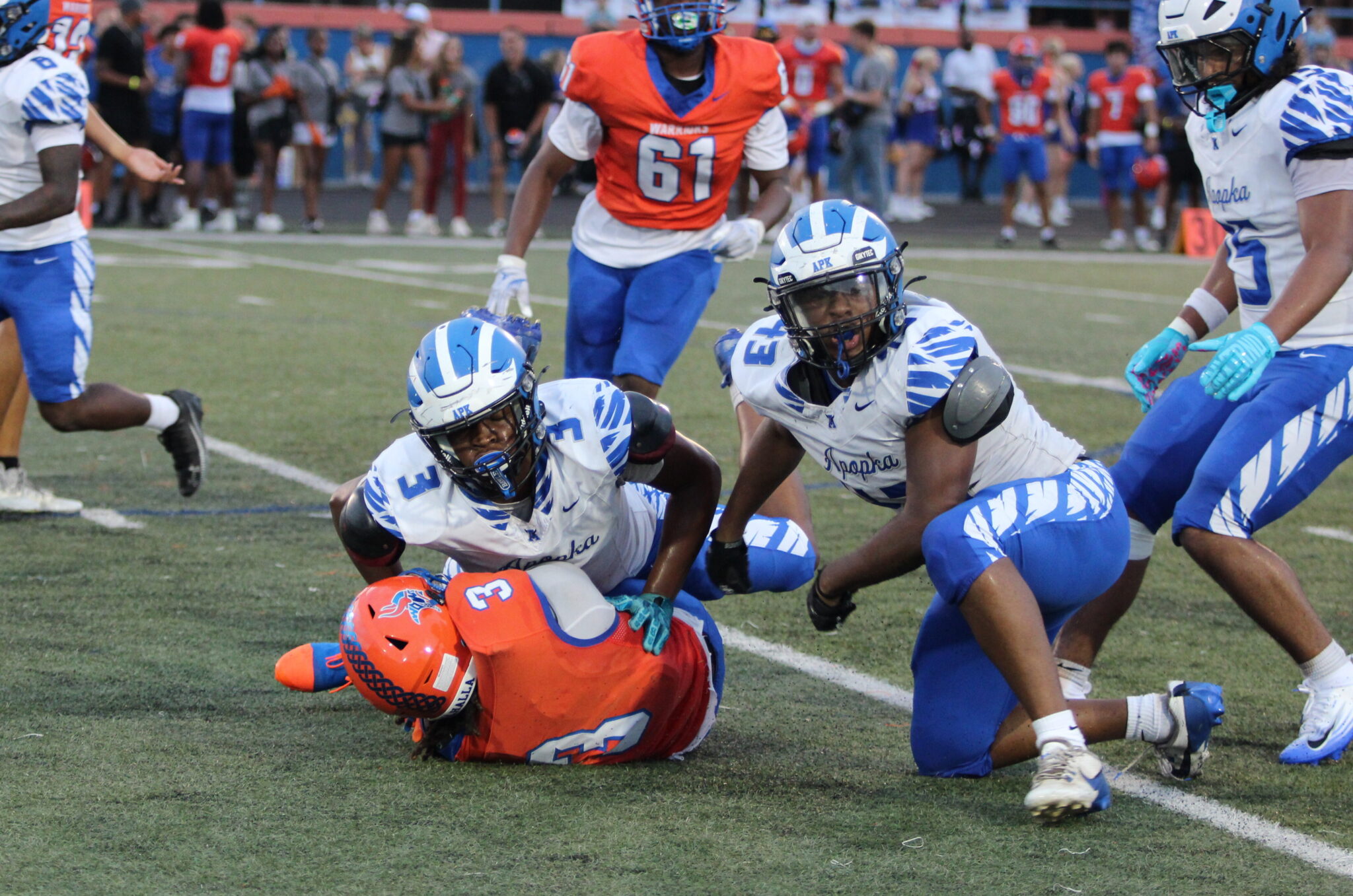 Kentrel Baker and Jakendall Kemp topple over the running back for a four yard loss.