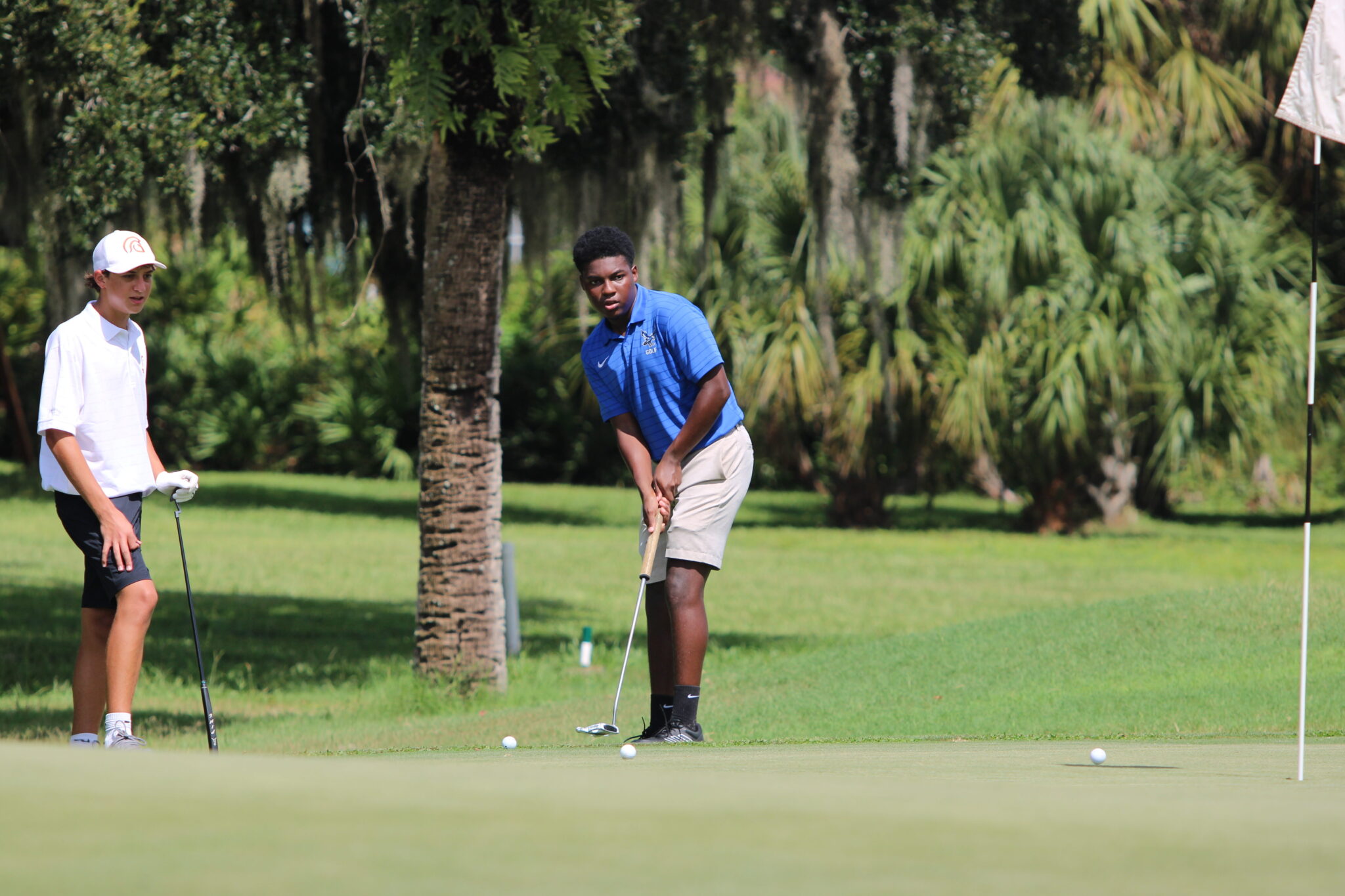 Kyler Ransom watches his putt approach the hole.