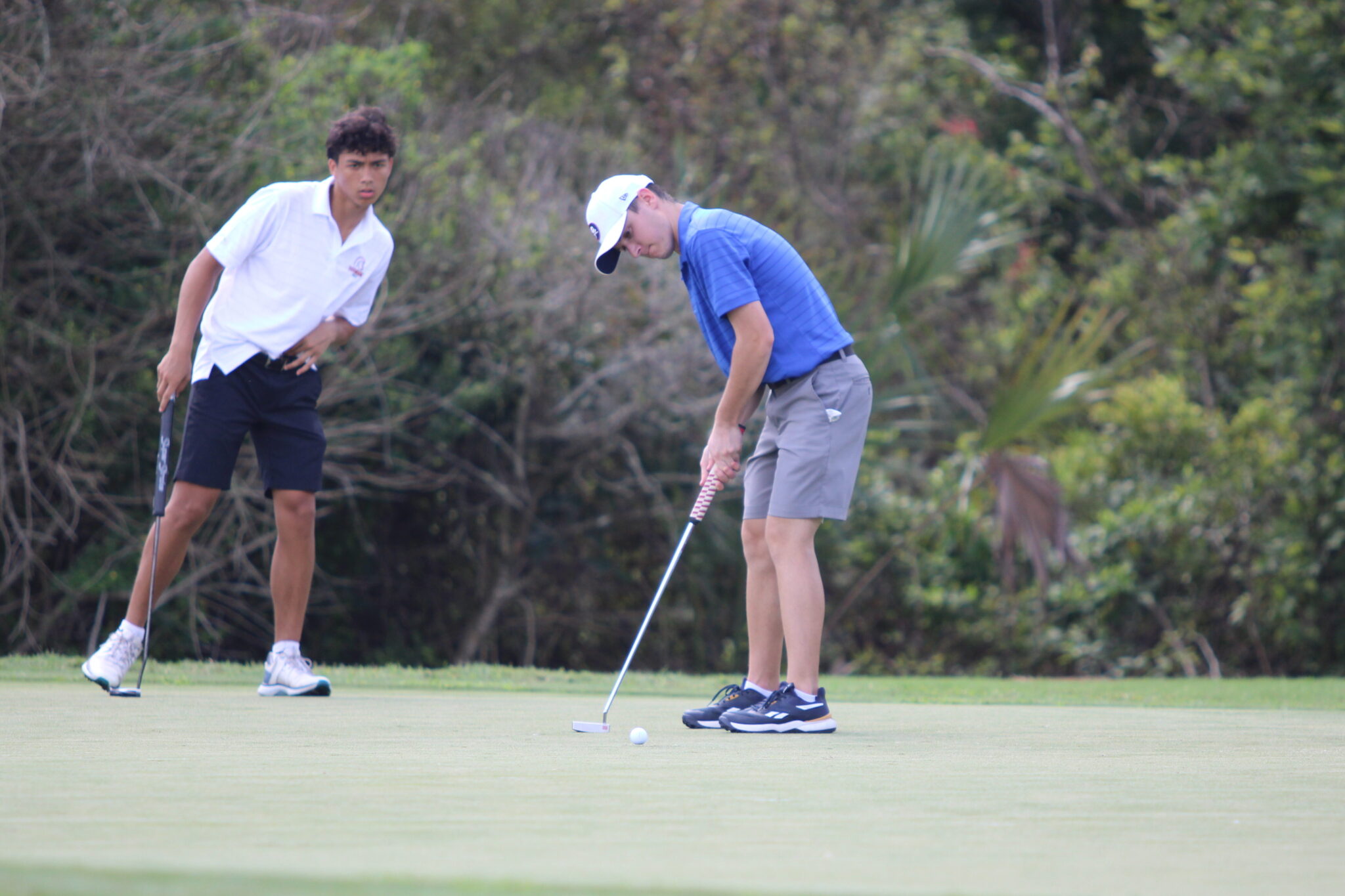 Paul Ancona putts in a shot on the 9th hole.