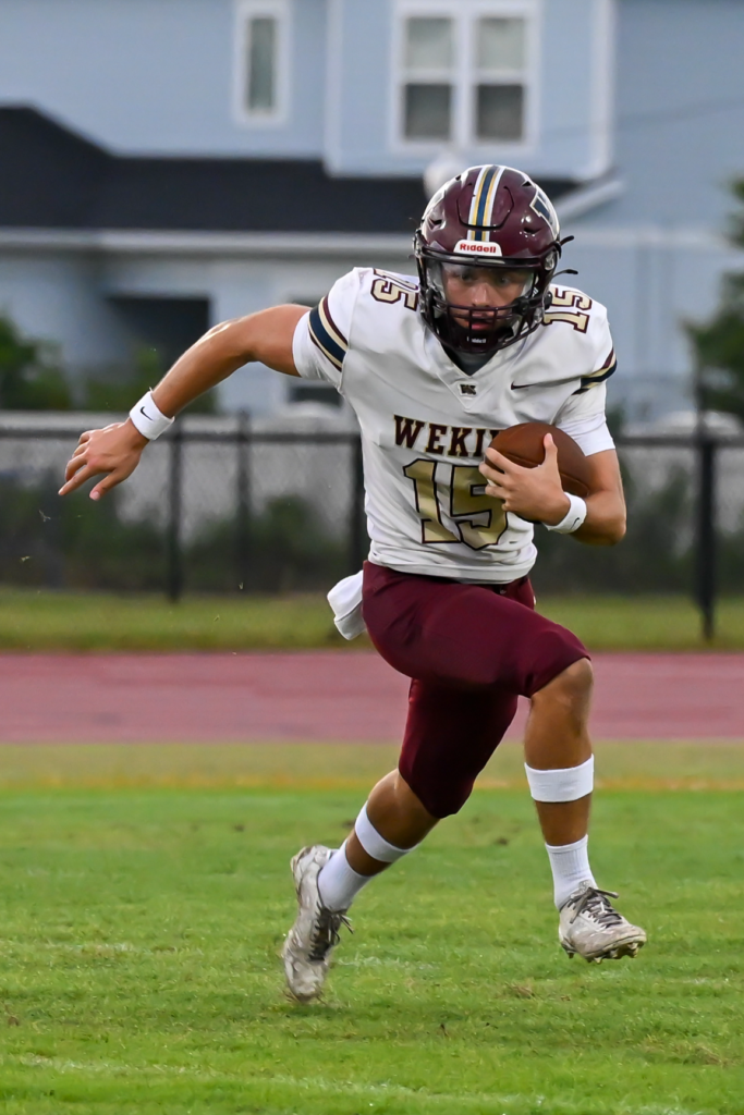 Quarterback Dominick Sanguine looks for running room against Lake Buena Vista on Friday.