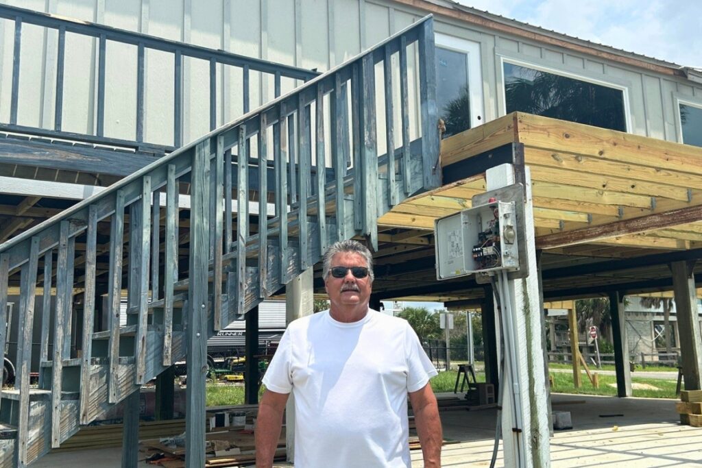Steinhatchee Chamber President Mark Reblin stands in front of the new Chamber building that is under construction.