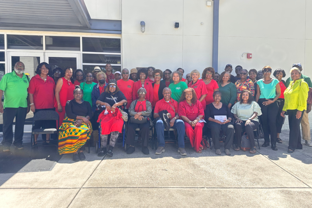 Members of the Apopka Progressive Seniors Club gather outside the John H. Bridges Community Center in Apopka on Tuesday, Aug. 11, before casting their ballots together during early voting for the Aug. 18 primary election. About 50 club members participated in the group voting outing after the club’s weekly meeting. Members wore red, green and black, colors associated with Black liberation.