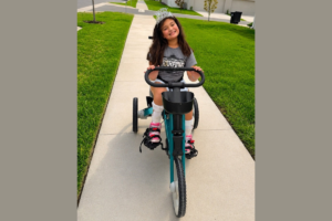 Apopka child with spina bifida receives adaptive tricycle