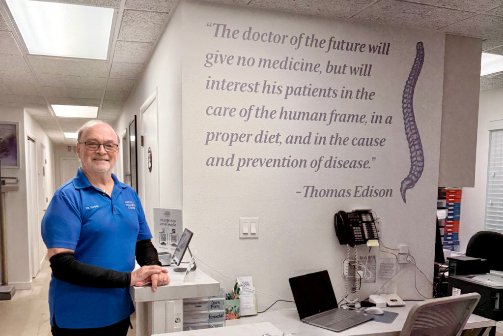 Dr. Adlai Green poses in the receptionist's office at Apopka Wellness Center.