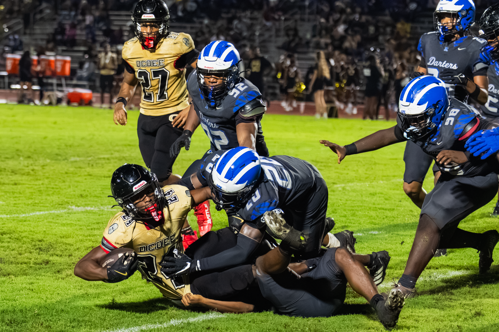 A flock of Blue Darters take down the Ocoee Knight ballcarrier.