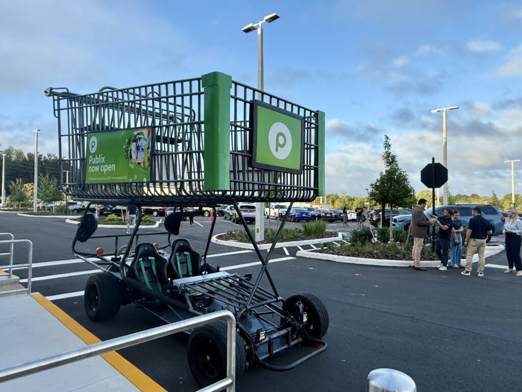 A gigantic shopping cart, complete with two go kart-like seats, welcomed guests in the parking lot of the new Publix.