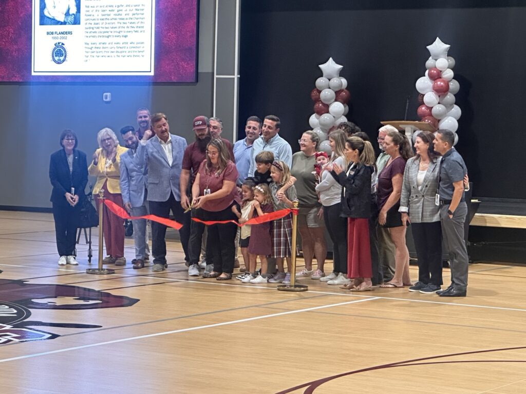 Central Florida Preparatory School head of school Julia Najera cuts the ribbon Friday, Aug. 28, to celebrate the opening of the Robert A. Flanders Athletic and Performing Arts Center. The 24,000-square-foot facility includes a gymnasium, classrooms and space for athletic, academic and performing arts programs.