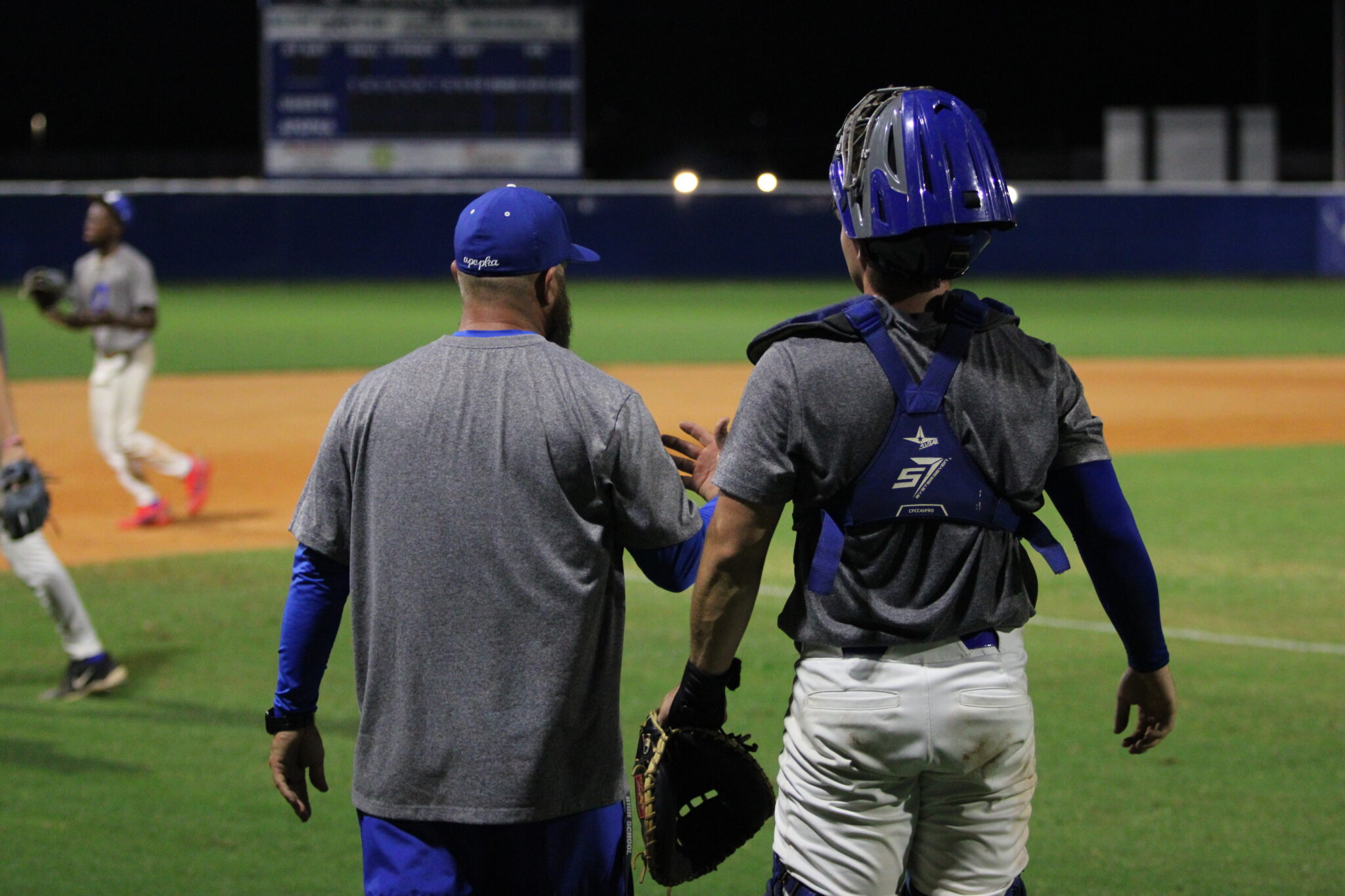 Coach Scott Garland speaks with Collin Van Fleet after an inning Thursday night, Sept. 24, against St. Cloud.