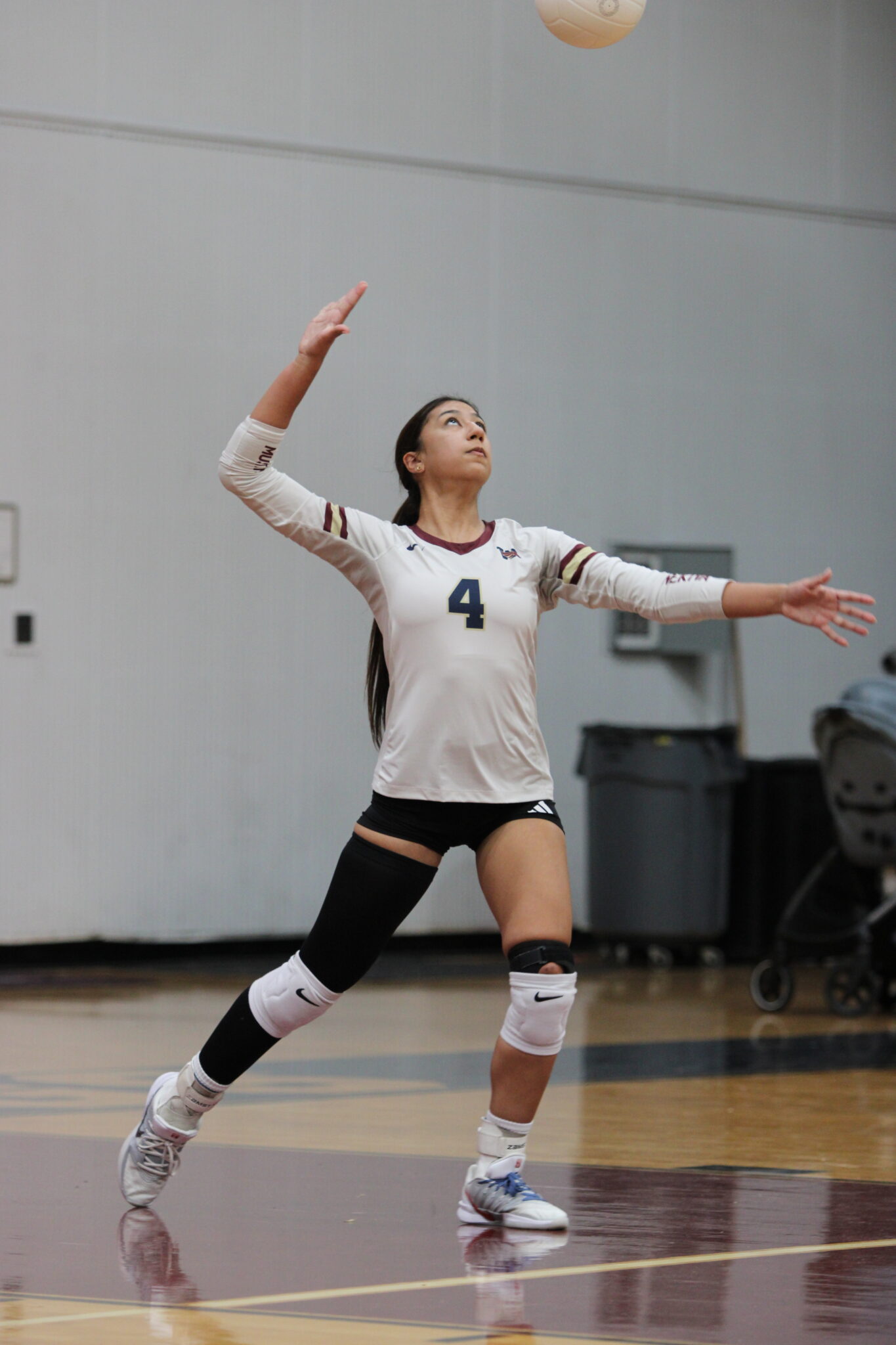 Elyanna Sanchez winds back to serve to Jones.