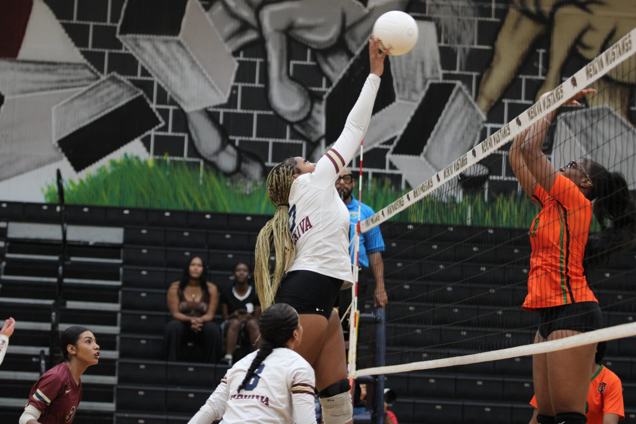 Ginia Reese high points the set pass from Espada and slams it over the net.