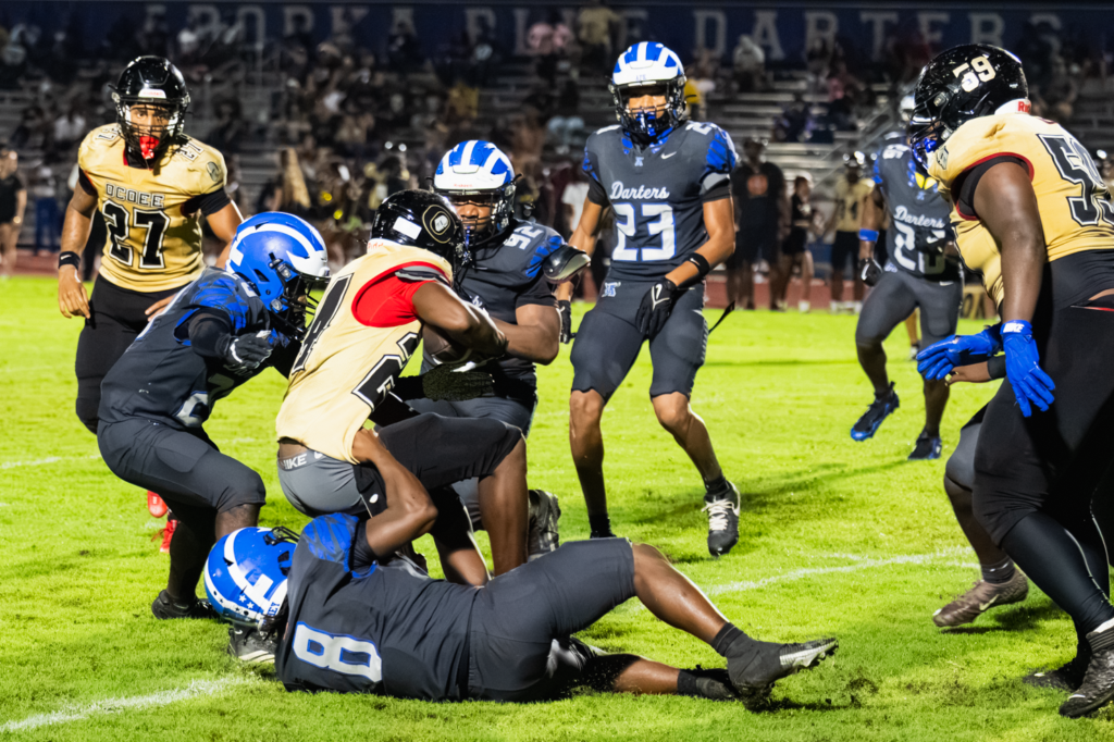 Le'Melle Griffin (8), Elysian Williams(20), and Marcus Young (92) gang tackle an Ocoee Knight.