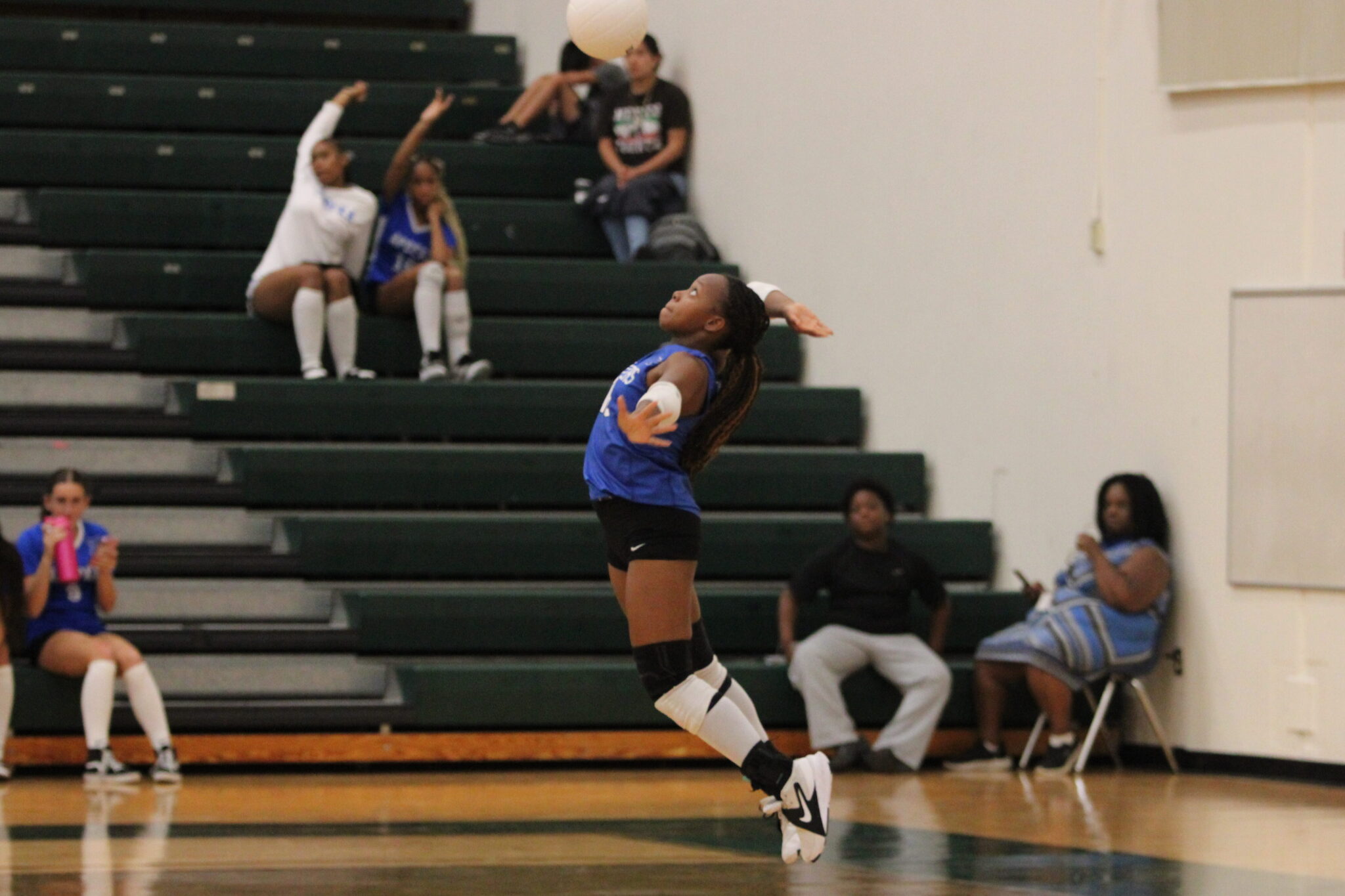 Marie Hughes leaps for a powerful serve in the first set.