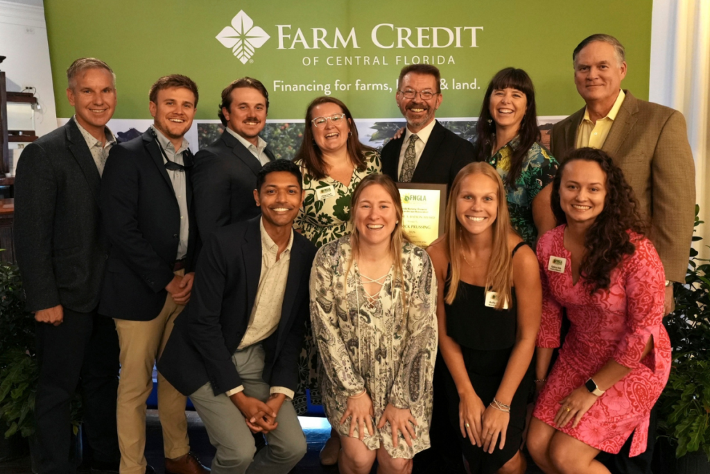 Patrick Prussing (back row, third from right) holds his Gene A. Batson Award while posing with luncheon attendees Aug. 27 at Highland Manor in Apopka. The award recognizes outstanding service and leadership in the Action Chapter of the Florida Nursery, Growers and Landscape Association.