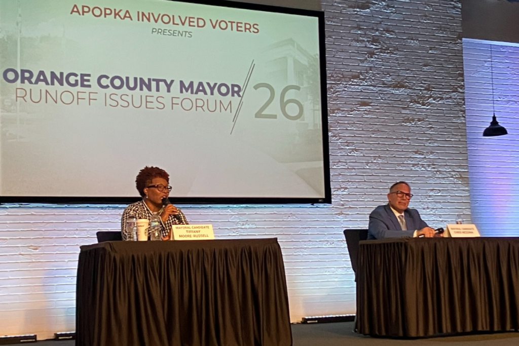 Orange County mayoral candidate Tiffany Moore Russell (left) answers a question as opponent Chris Messina listens during the Apopka Involved Voters runoff issues forum Monday at Victory Church in Apopka.