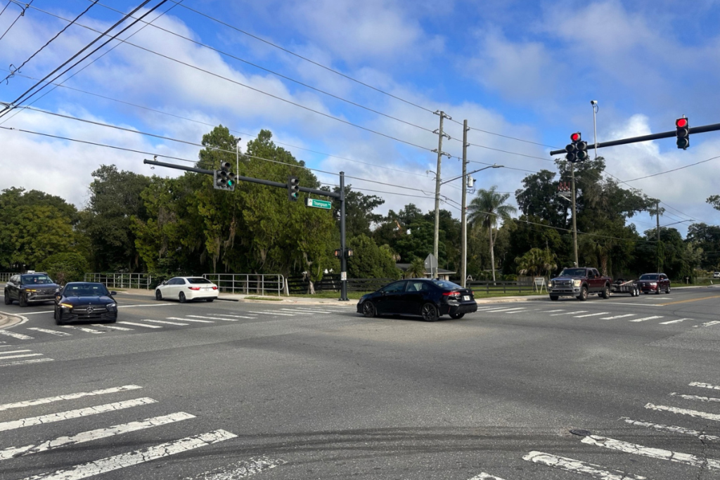 Vehicles travel through the intersection of North Thompson Road and Votaw Road Thursday morning after North Thompson Road reopened Wednesday afternoon following about 30 days of closure for Orange County Utilities’ Wekiwa Springs Septic-to-Sewer Project.