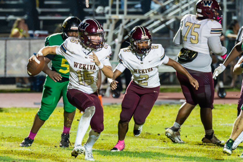 Dominick Sanguine (No. 15) rolls out for a pass against Lake Minneola on Friday.