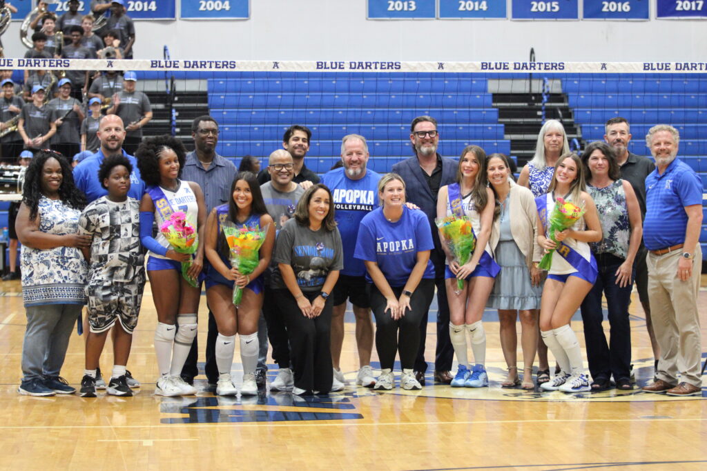 Apopka volleyball seniors, family, and staff group up for senior night.