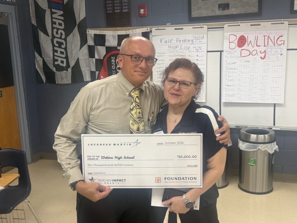 Wekiva High School's AFJROTC senior instructor and retired Col. Scott Stewart (left) poses alongside Keely Kenney (right), senior grants manager for Foundation for Orange County Public Schools.