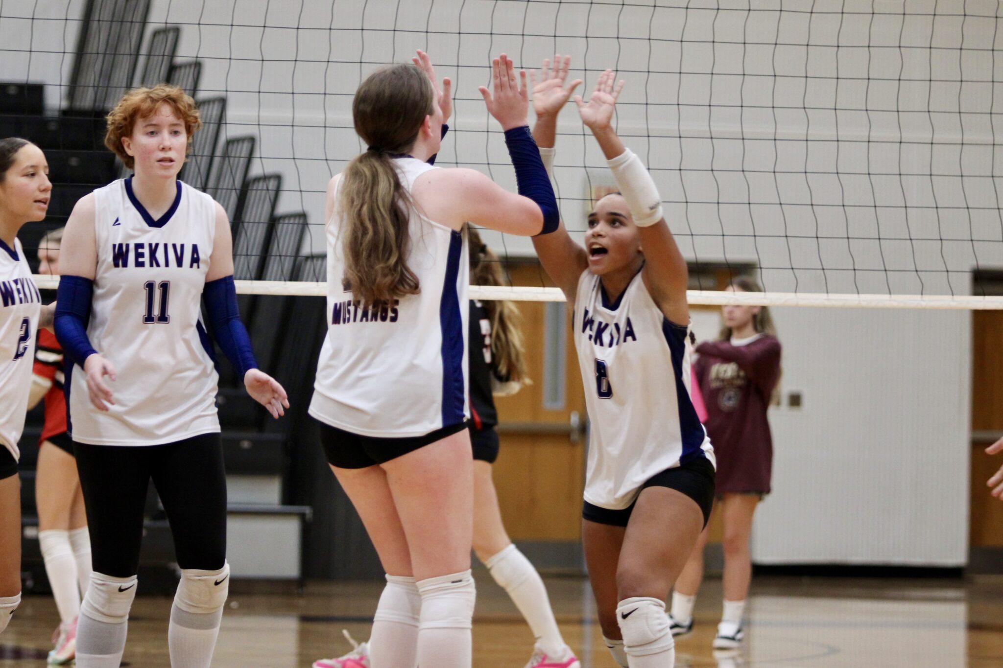 Avianna Mater and Isabella Espada high-five after their set and kill connection in the fourth set.