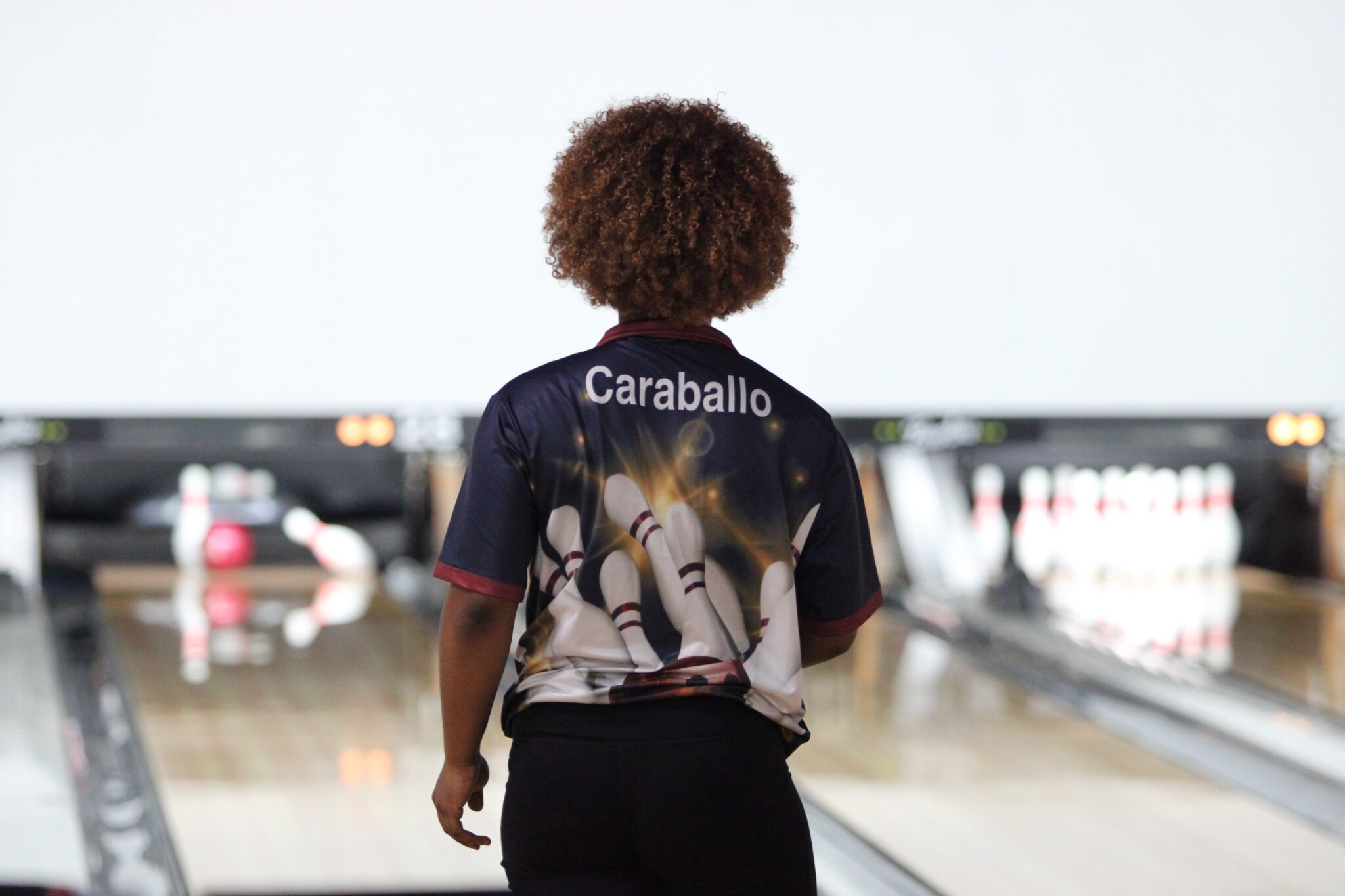 Cindy Caraballo watches her pins crash down for a spare.