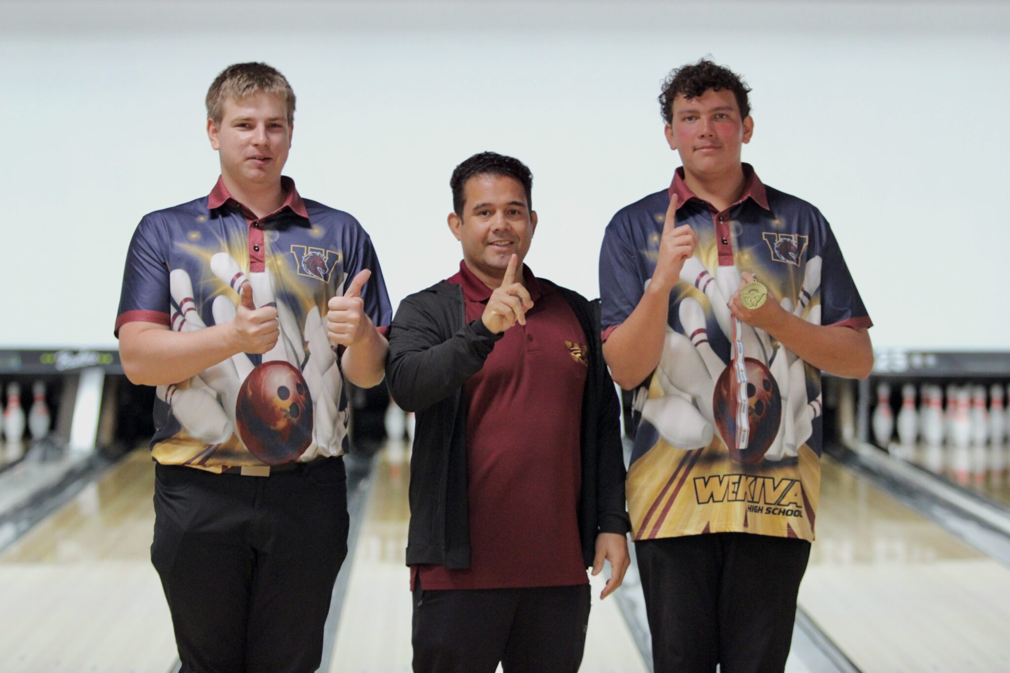 Coach Lenin Vazquez with his two All-Metro team performers, William Warren and Nathan Karcher.