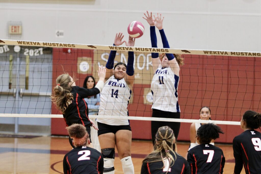 Destiny Rosado and Leona Salasek combine for a block on Edgewater's kill attempt.