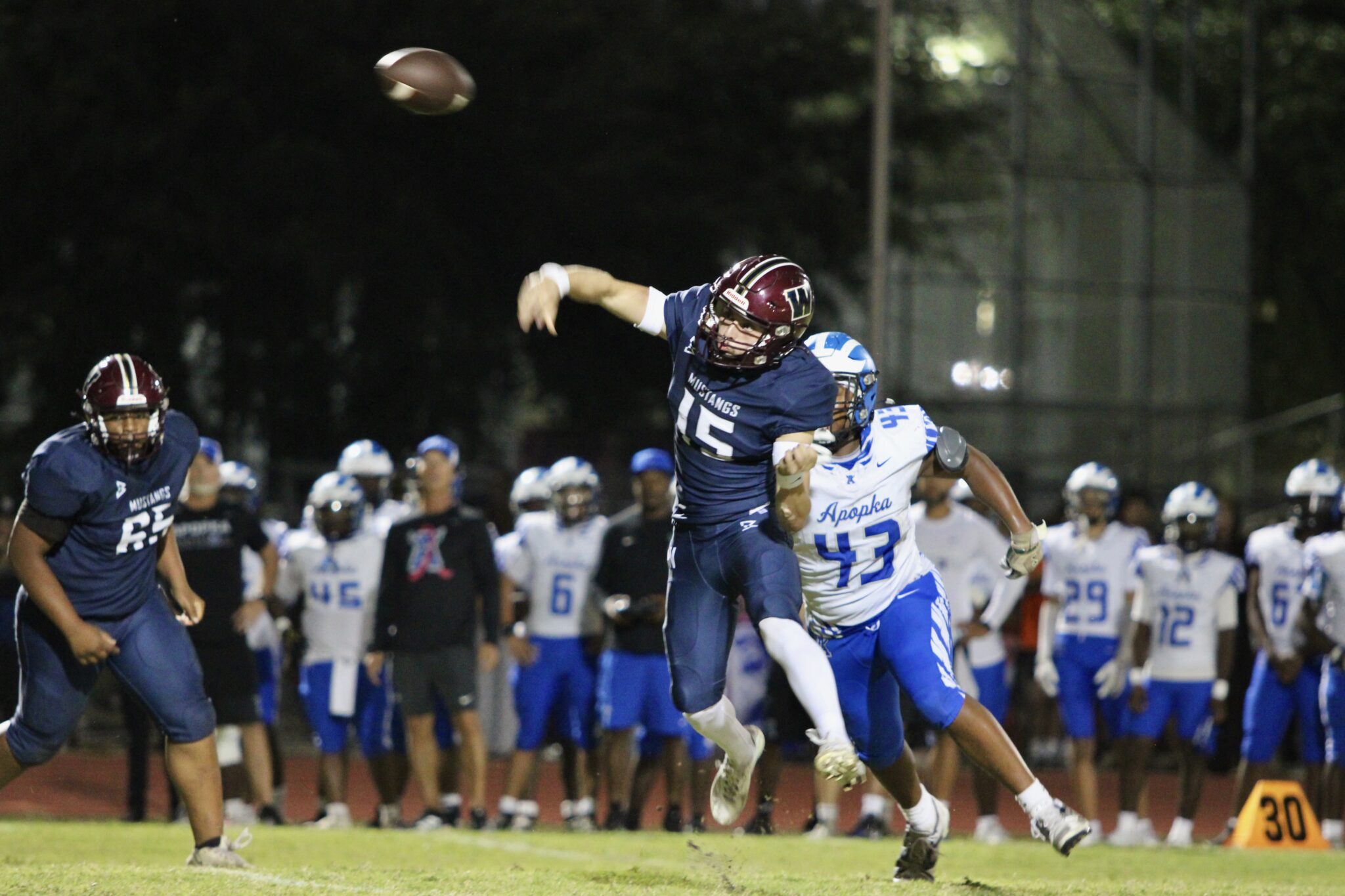 Dominick Sanguine makes a throw on the run while being rushed out of the pocket by Kentral Baker.