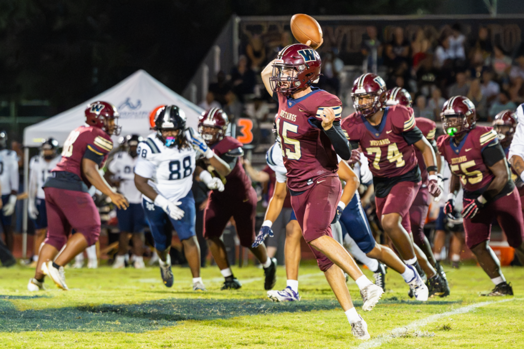 Dominick Sanguine pump fakes a throw while on a quarterback scramble.