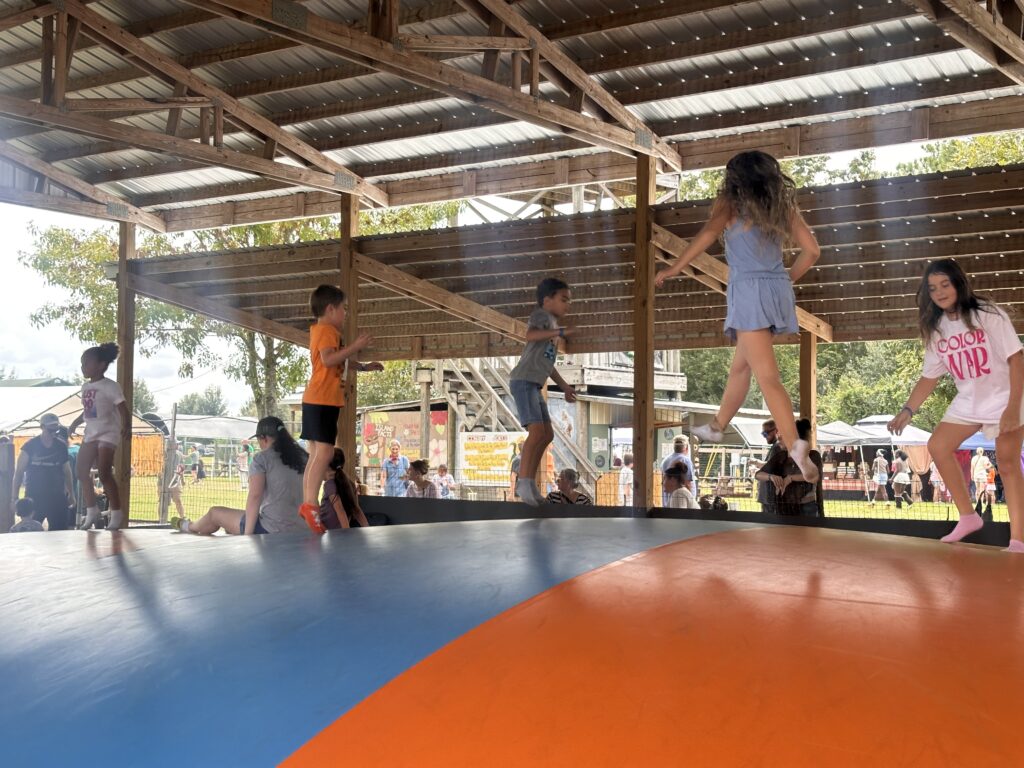 Children play on the Jumbo Jumper air pillow at Great Scott Farms, one of several family activities offered during the farm’s annual fall festival.