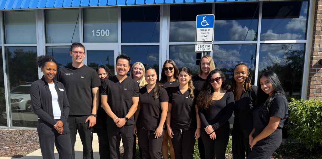 The Aspen Dental Apopka team smiles in front of the office, located at 1500 W. Orange Blossom Trail.