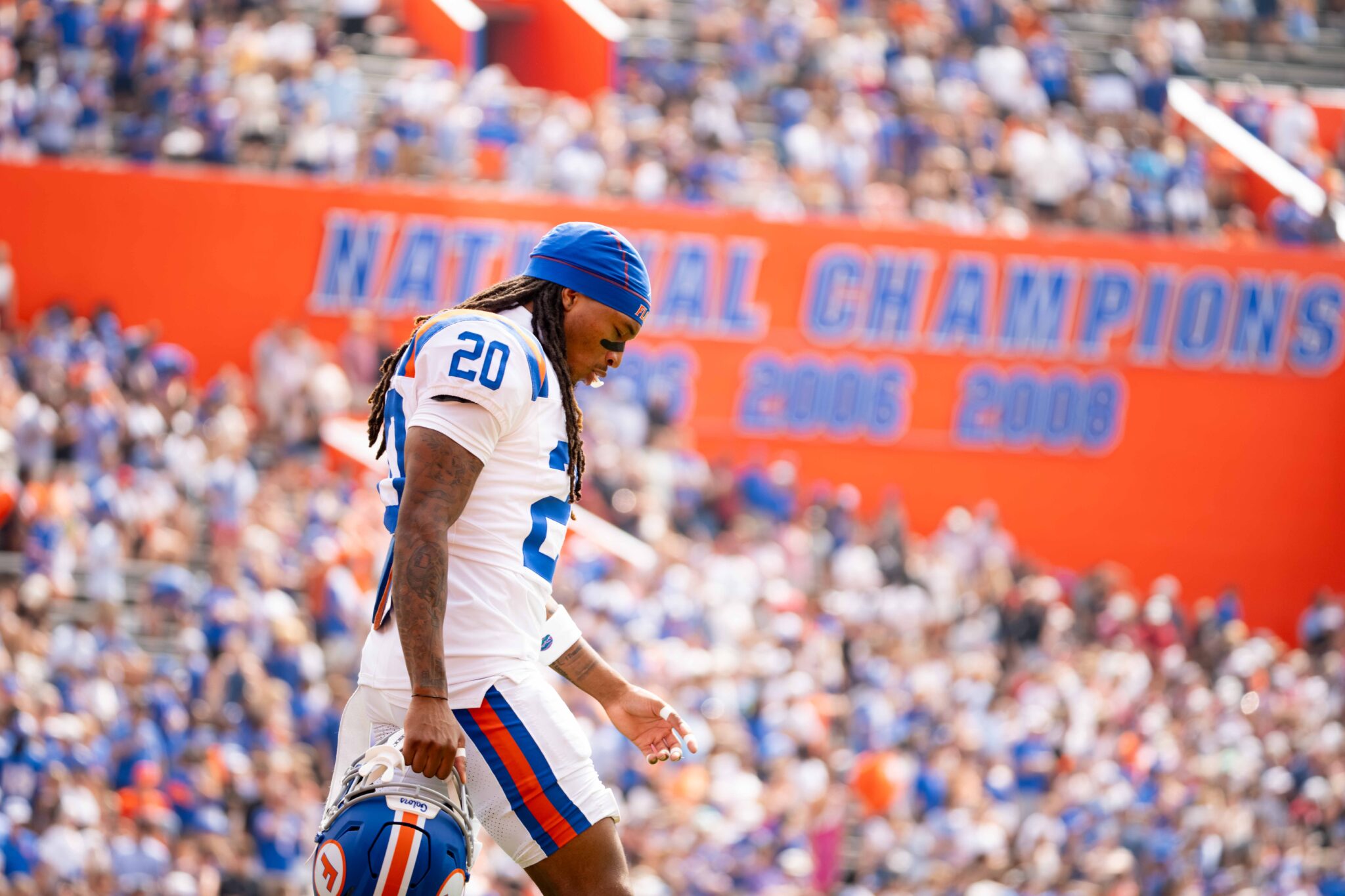 Florida's Kanye Clark carries his helmet across the field during Saturday’s game against South Carolina at Ben Hill Griffin Stadium. Photo by Tim Rodriquez