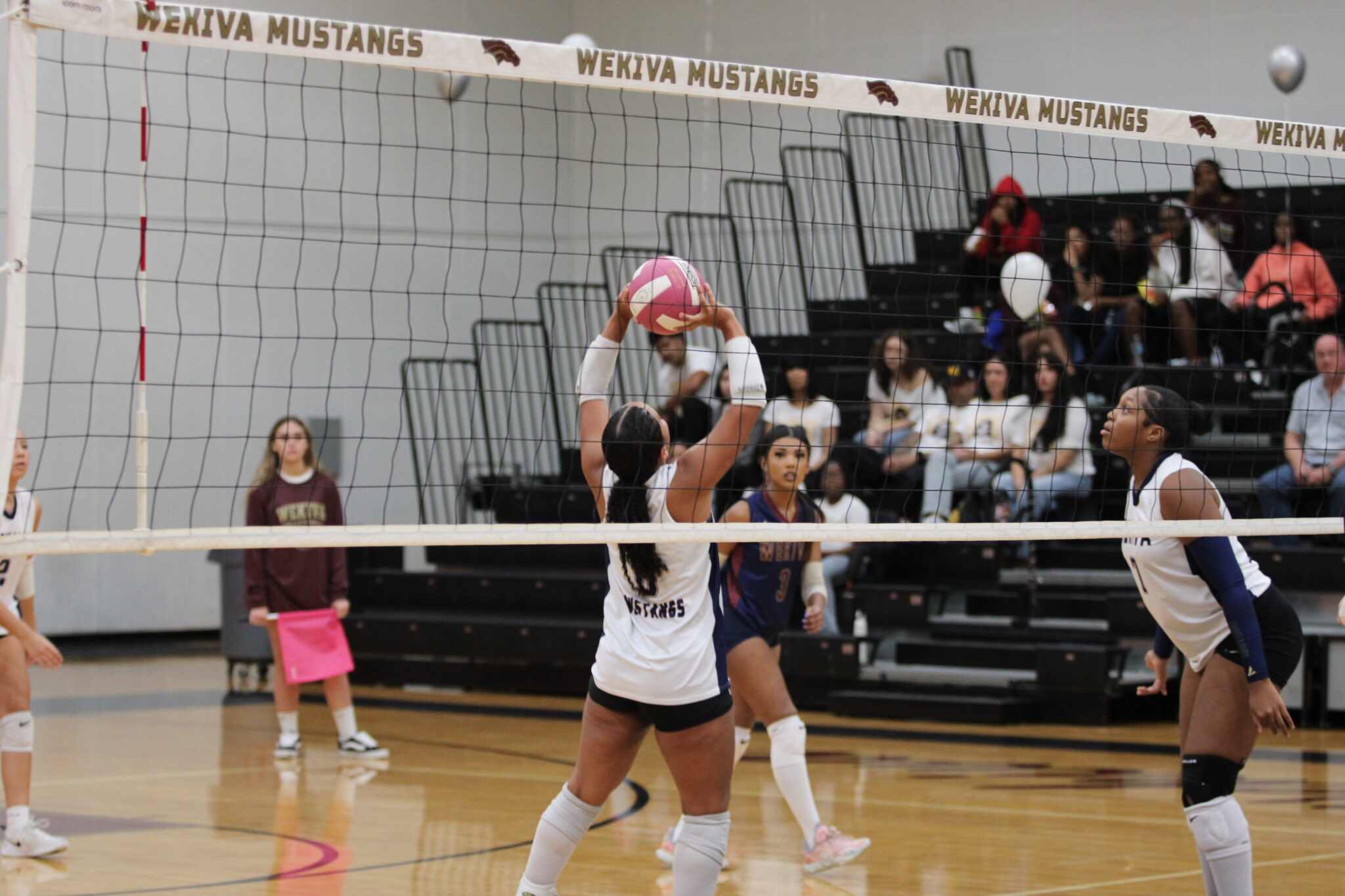 Isabella Espada sets a ball at the net.