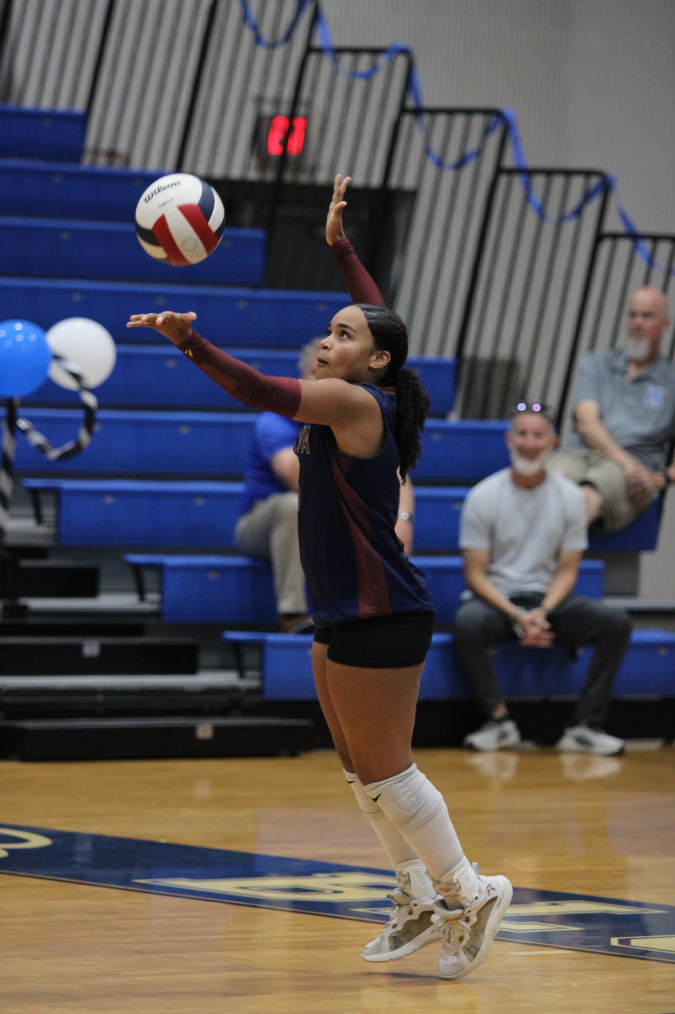 Isabella Espada tosses up a serve to Apopka.