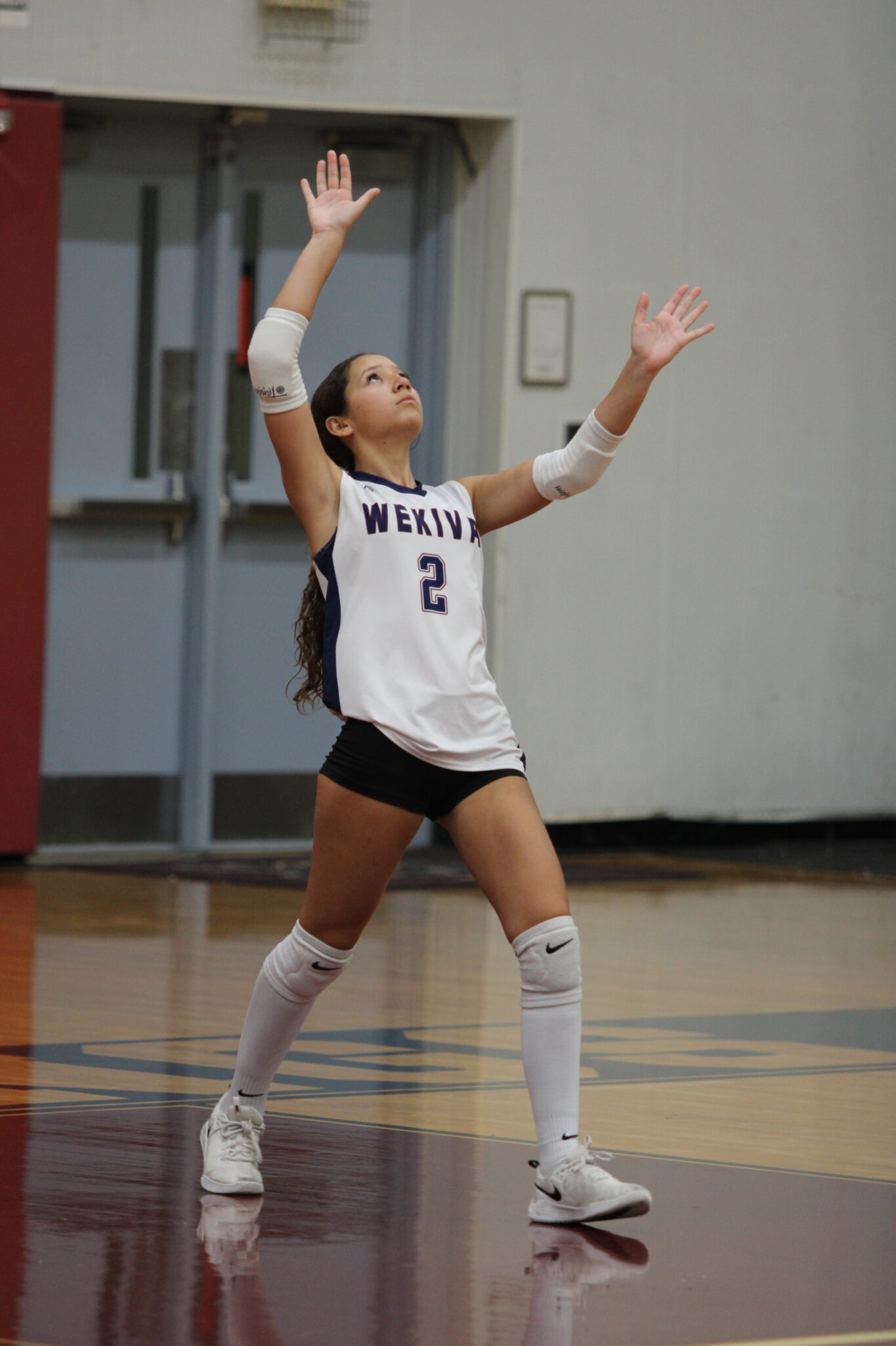 Isabella Mancilla tosses up a serve and swats it to South Lake.
