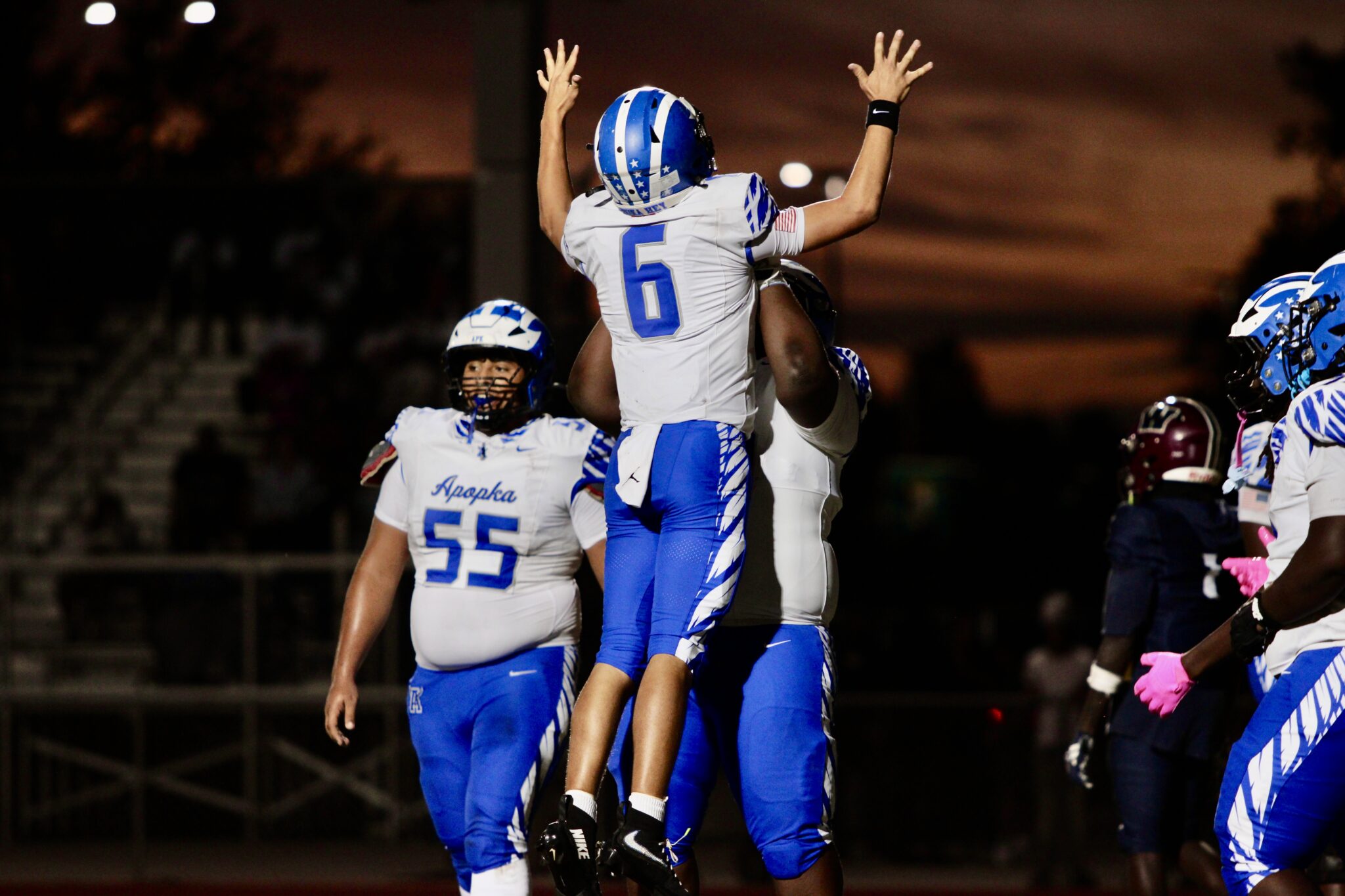 Jinel Rivera lifts Kai Goodling after his QB sneak into the end zone.