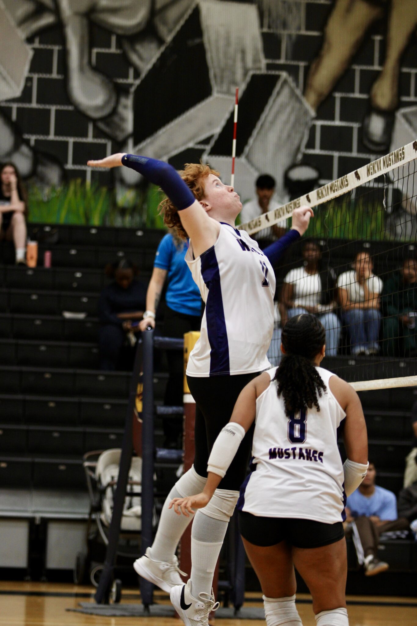 Leona Salasek leaps up at the net for a kill set from Isabella Espada.